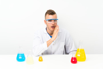 Young scientific with lots of laboratory flask whispering something