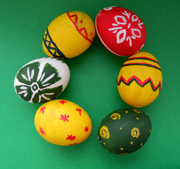 multicolored Easter eggs on a green background