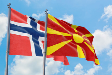 Macedonia and Bouvet Islands flags waving in the wind against white cloudy blue sky together. Diplomacy concept, international relations.