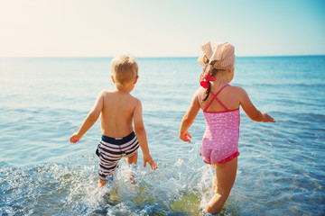 Boy and girl playing on the beach