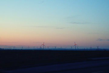 Fototapeta na wymiar landscape with sunset and wind farm windmills after dark