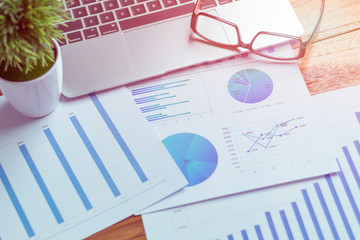 Charts and graphs are placed on the desks, data, and statistical performance of the company in the past year.