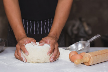 The chef is spinning the dough in the kitchen