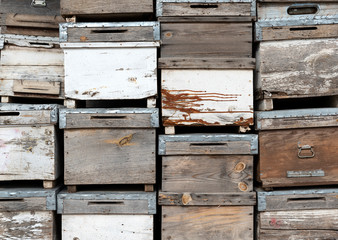 Old wooden boxes background. Old beehives.