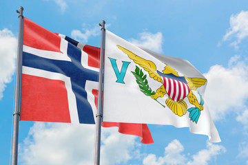 United States Virgin Islands and Bouvet Islands flags waving in the wind against white cloudy blue sky together. Diplomacy concept, international relations.
