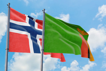 Zambia and Bouvet Islands flags waving in the wind against white cloudy blue sky together. Diplomacy concept, international relations.
