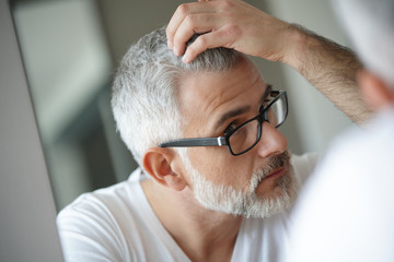 Portrait of man concerned by hair loss