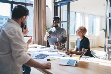 Black man speaking with colleagues during meeting