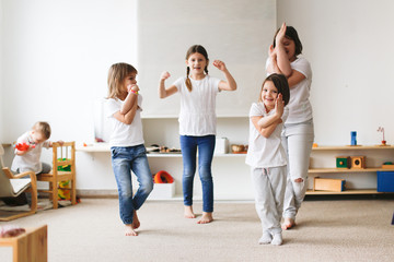 Fototapeta premium Funny children of different ages in play yoga