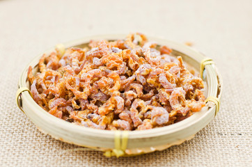 Dried sea shrimp on indoor background
