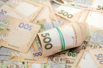 twisted 500 hryvnias against a hryvnias background.