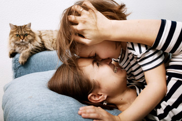 Close-up of hugging affectionate mother and daughter in same clothe