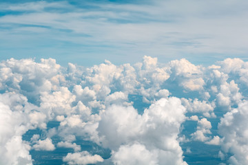 Naklejka na ściany i meble Blue sky with fluffy clouds. Aerial view from airplane window