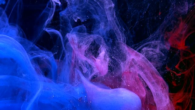 Stylish abstract modern background. Colored space background. Blue, white and red watercolor ink in water on a black background. Cool trending screensaver.