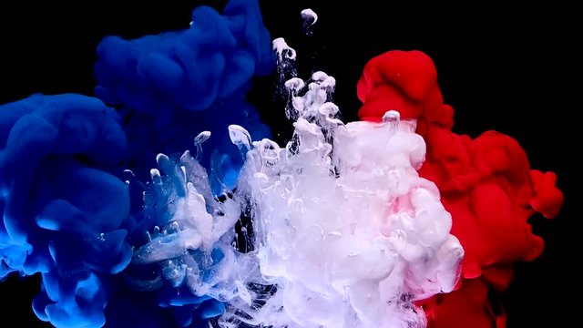 France flag made of colored ink on a black background. Stylish abstract modern background. Blue, white and red watercolor ink in water. A powerful explosion of colors. Cool trending screensaver.