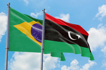 Libya and Brazil flags waving in the wind against white cloudy blue sky together. Diplomacy...