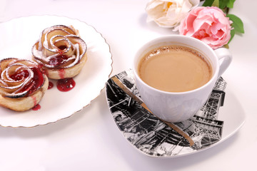 apple strudel in the form of a rose with a red apple and a cup of coffee