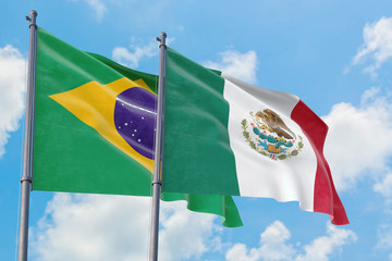 Mexico and Brazil flags waving in the wind against white cloudy blue sky together. Diplomacy concept, international relations.