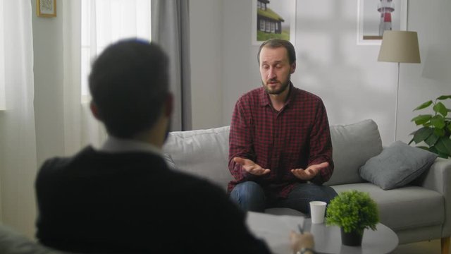 sad young man in Therapy session - Help, support, medical