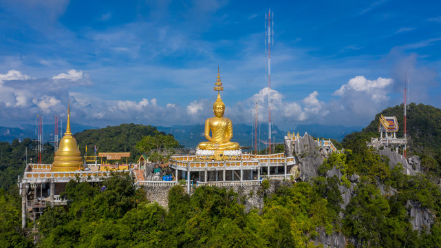 Aerial view Tiger Cave Temple, Buddha on the top Mountain with blue sky of Wat Tham Seua, Krabi, Thailand