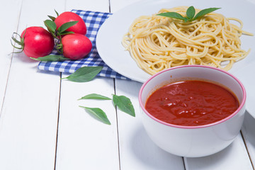 Spaghetti pasta with and tomato sauce on wood background