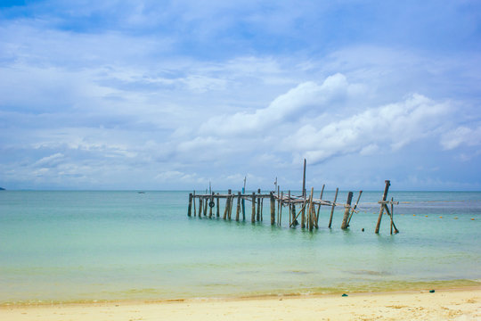 Wood bridge on beach with beautiful sky
