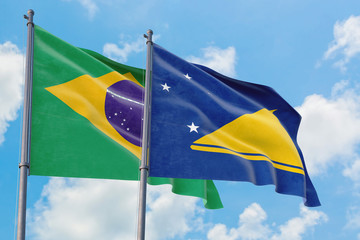 Tokelau and Brazil flags waving in the wind against white cloudy blue sky together. Diplomacy concept, international relations.
