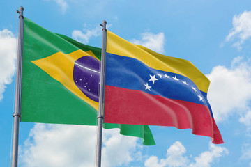 Venezuela and Brazil flags waving in the wind against white cloudy blue sky together. Diplomacy concept, international relations.