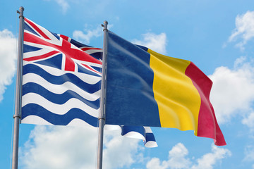 Chad and British Indian Ocean Territory flags waving in the wind against white cloudy blue sky together. Diplomacy concept, international relations.