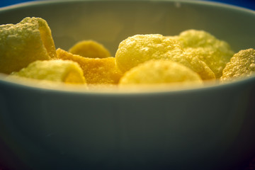 Far-far (also fryum) in a bowl which is an Indian snack food composed primarily of potato starch and tinted sago.