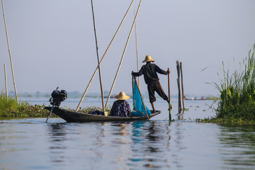 The fisherman of the Inle Lake arranges fishing nets