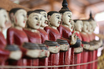 Figurines of monks collecting donations in the ancient souvenir market in Myanmar