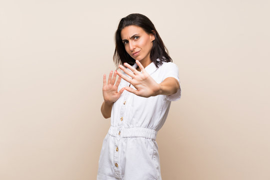 Young woman over isolated background nervous stretching hands to the front