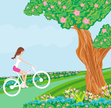 Girl is riding bike on a spring day