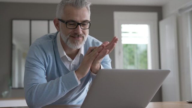 Man in office working on laptop computer