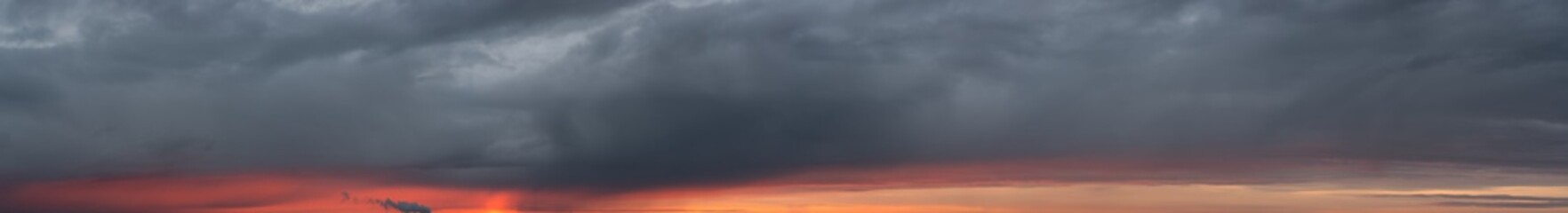 Fantastic dark thunderclouds at sunrise