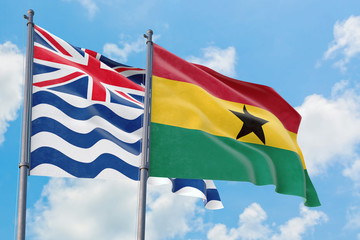 Ghana and British Indian Ocean Territory flags waving in the wind against white cloudy blue sky together. Diplomacy concept, international relations.