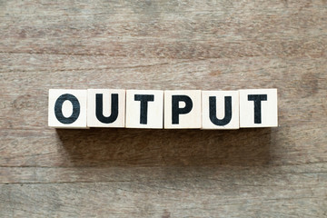 Fototapeta premium Letter block in word output on wood background