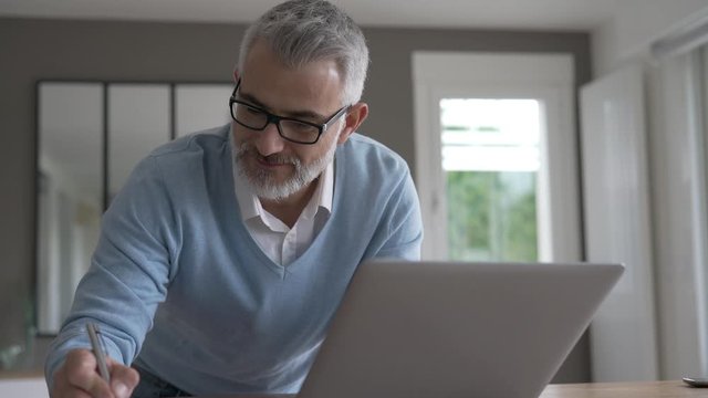Man in office working on laptop computer