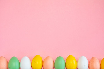 Fototapeta na wymiar Colorful easter eggs on pink background