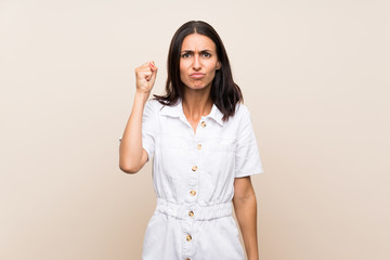 Young woman over isolated background with angry gesture