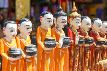 Figurines of monks collecting donations in the ancient souvenir market in Myanmar