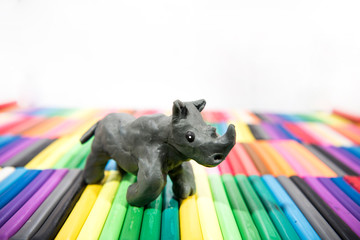 Play clay Animals. Rhinoceros on colored background.