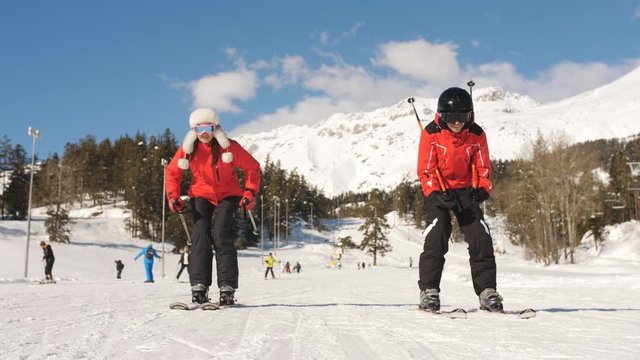 A couple of skiers at a ski resort.