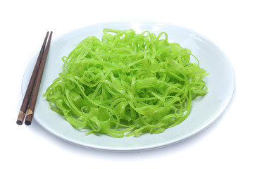 green noodles on dish isolated on white background