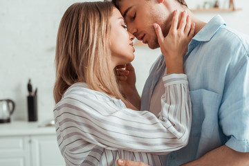 attractive woman with closed eyes touching boyfriend