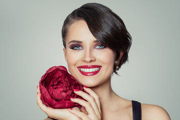 Beautiful smiling woman with trendy makeup and haircut, close up portrait
