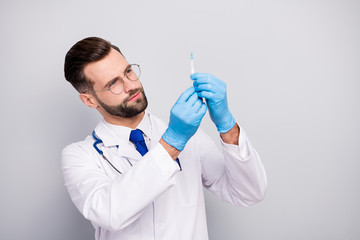Close-up portrait of his he nice attractive smart clever focused experienced qualified bearded doc paramedic preparing prick drug pharmacy isolated on light white gray pastel color background