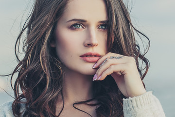 Young pretty woman with curly brown hair outdoor