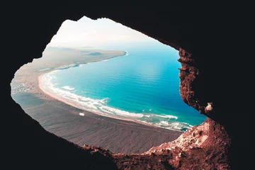 Fototapete Kanarische Inseln Cave from Mirador del Bosquecillo, Risco de Famara, Lanzarote, with beach view, Cueva de Famara, Lanzarote